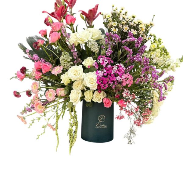 Lilium and the delicacy of Roses with enchanting wild touches of Trachelium and Amaranthus
